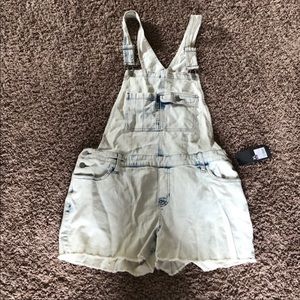 Acid washed denim overall shorts.